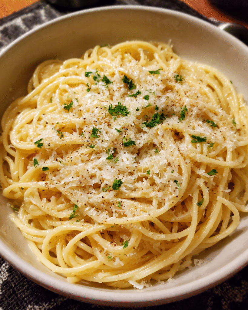 Garlic Parmesan Pasta served in a bowl with grated Parmesan