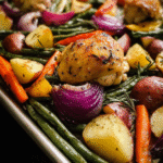 One Pan Chicken with Vegetables roasted on a sheet pan with carrots, green beans, and potatoes