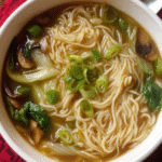 Quick noodle soup with bok choy and green onions in bowl