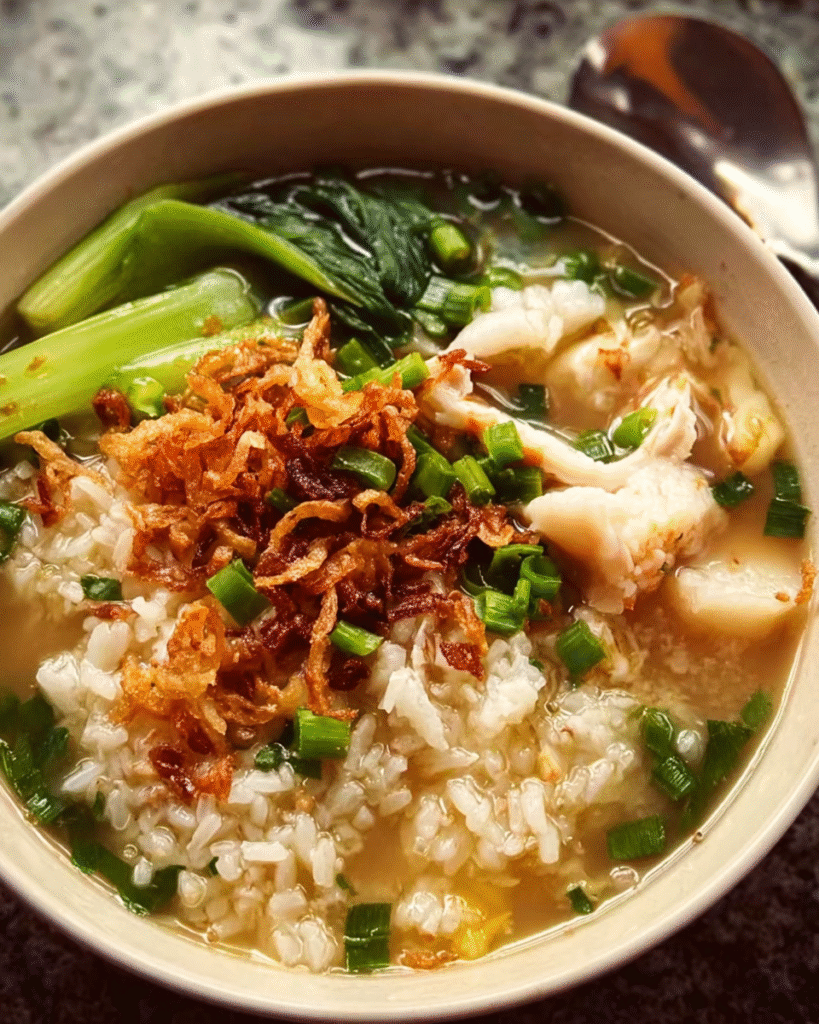 Bowl of Asian-style rice soup with fish and greens