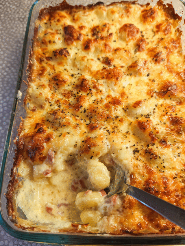 Baked creamy gnocchi in a casserole dish with melted golden cheese