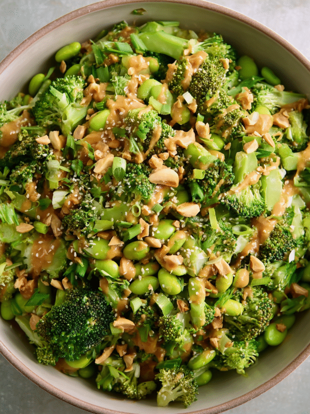 Broccoli Salad with Peanut Sauce in a bowl topped with roasted peanuts and cilantro