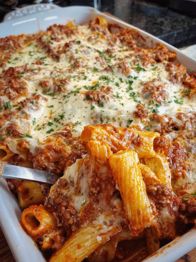 Cheesy baked rigatoni with melted mozzarella and meat sauce in a baking dish