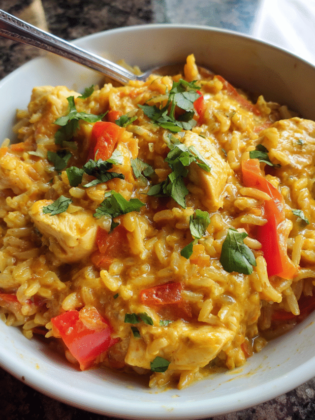 Chicken curry rice bowl with coconut milk and fresh cilantro