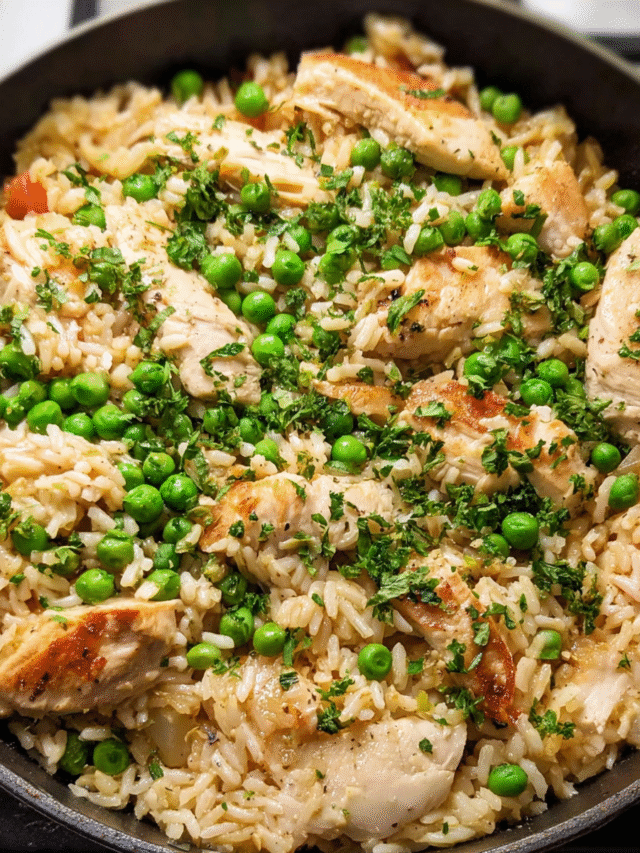Chicken and rice skillet with peas and parsley in a large pan
