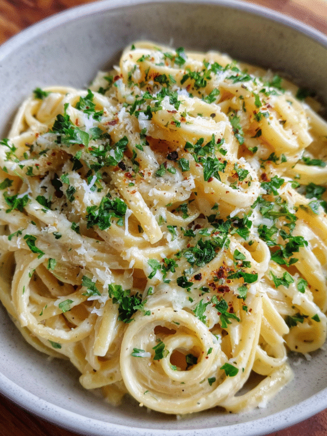 Creamy garlic butter pasta in a skillet with parsley