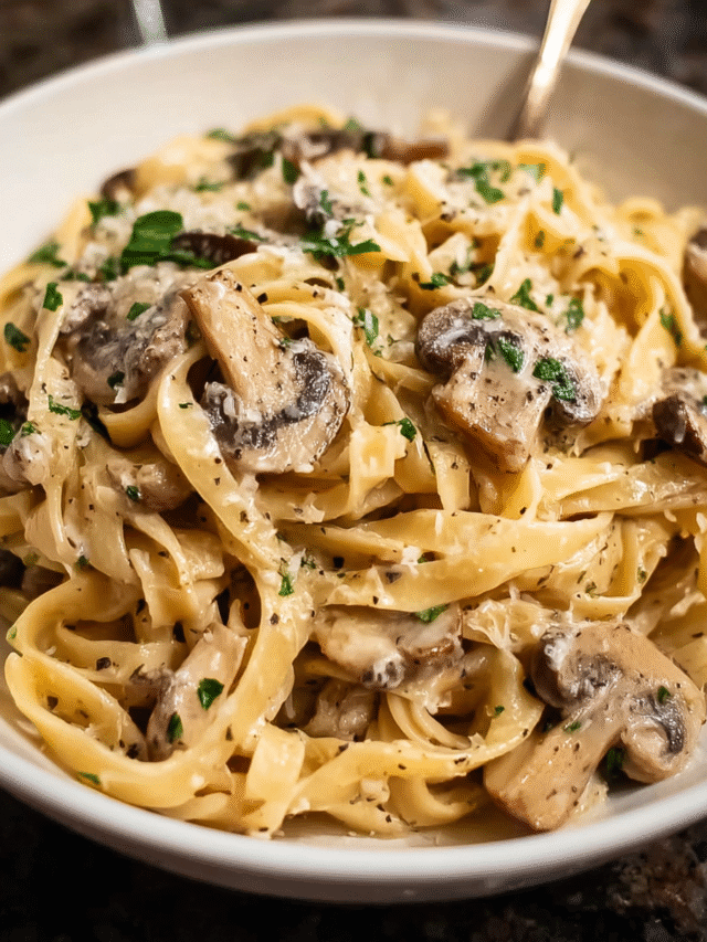 Creamy mushroom pasta in a skillet garnished with Parmesan