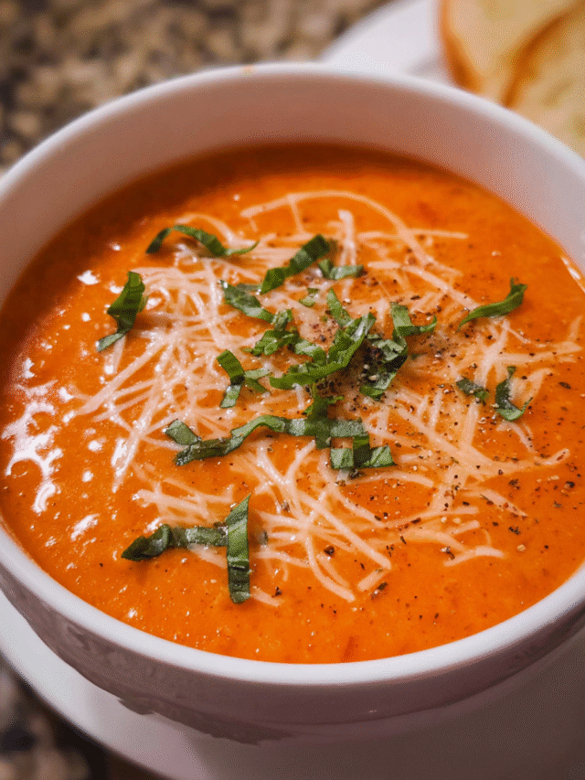 Bowl of creamy tomato soup with basil and parmesan