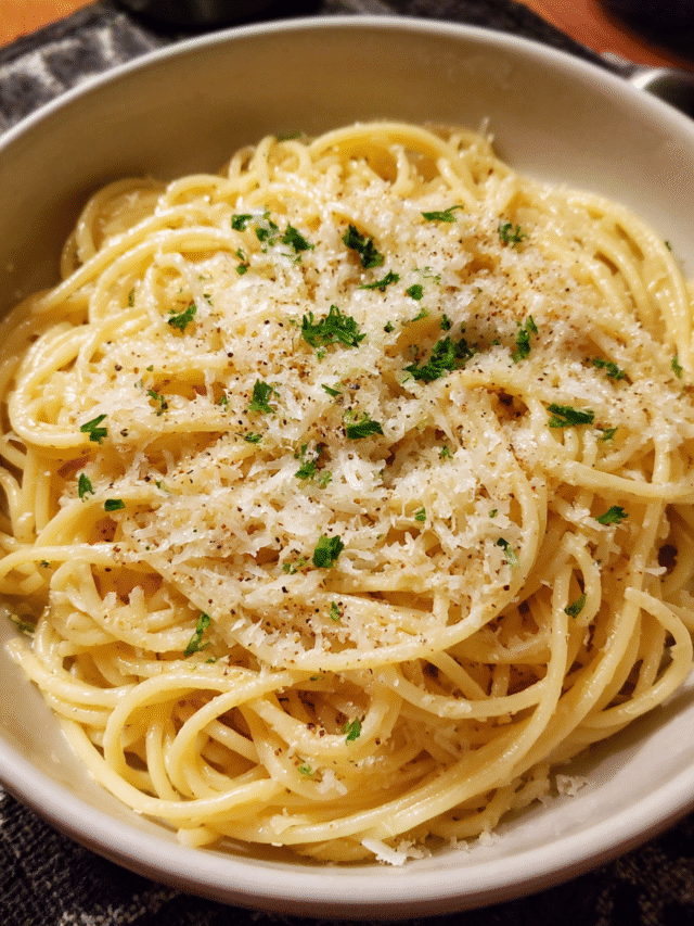 Garlic Parmesan Pasta served in a bowl with grated Parmesan