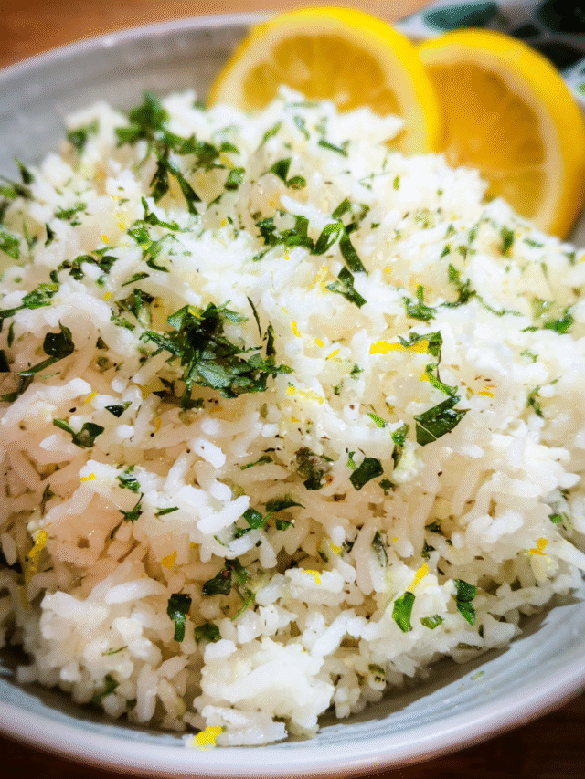 Bowl of lemon garlic herb rice topped with fresh parsley and lemon zest