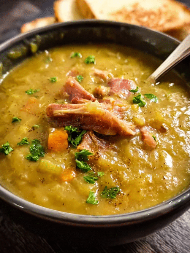Slow-cooked pea and ham soup in a bowl topped with parsley