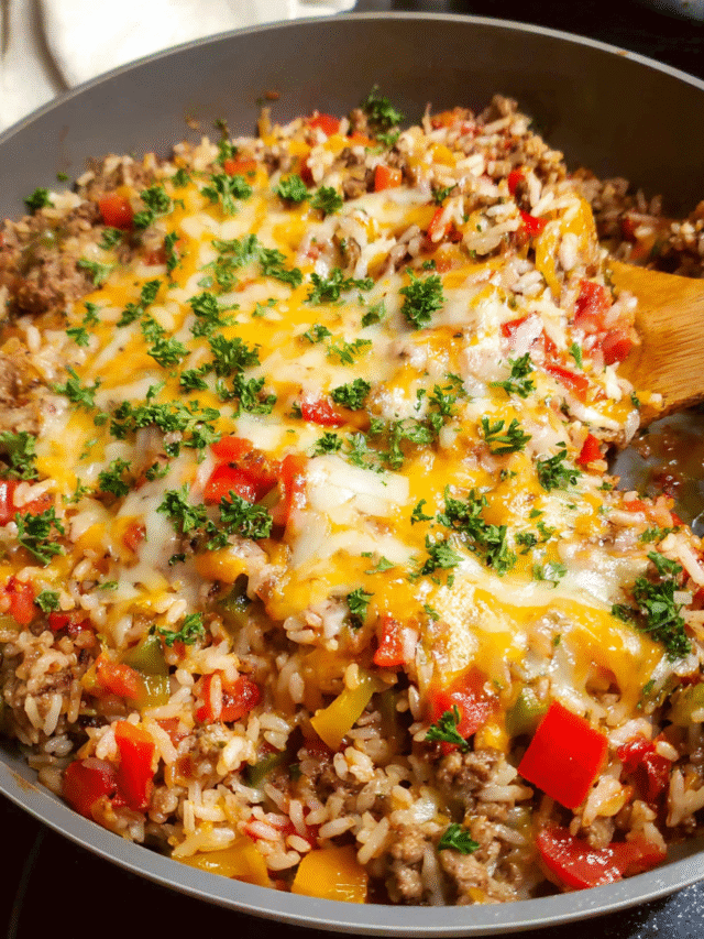 Stuffed pepper skillet with ground beef, rice, and melted cheese in a cast iron pan