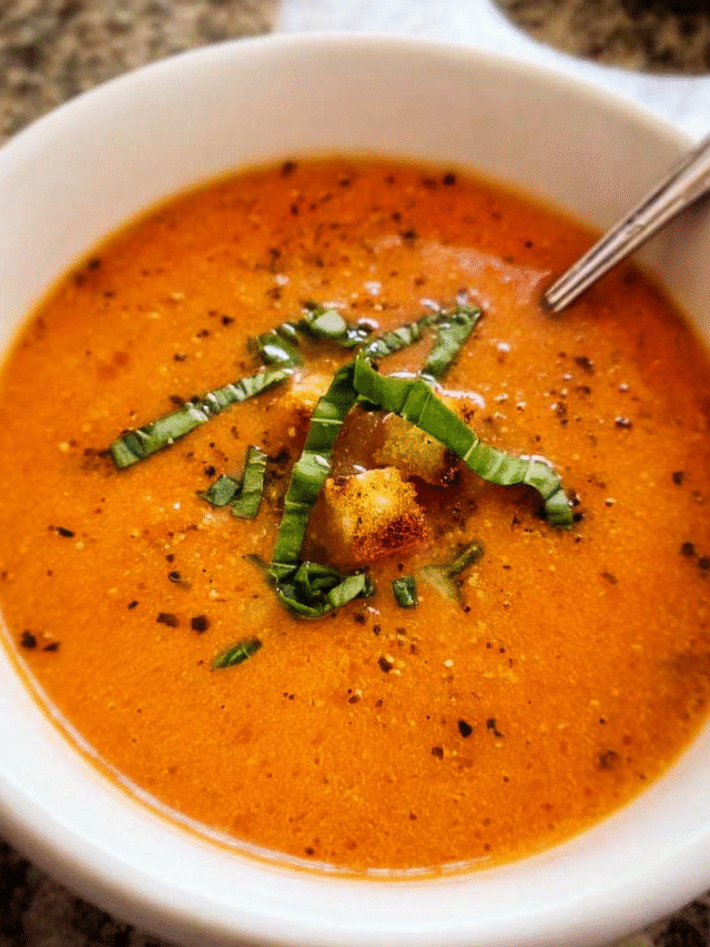 Creamy tomato basil soup served with fresh basil and parmesan