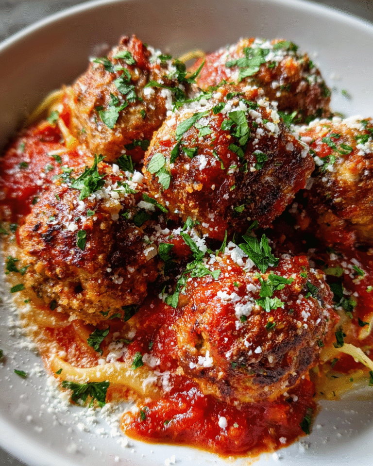Juicy baked Italian meatballs served with pasta and marinara sauce