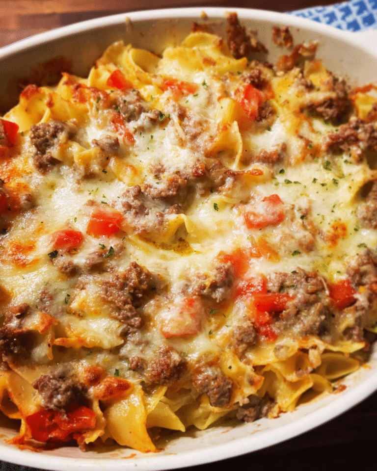 Baked beef and cheese casserole with melted cheddar on top