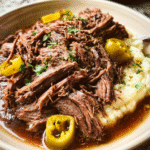 Slow cooker Mississippi pot roast with shredded beef and peperoncini peppers
