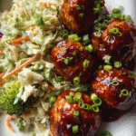 Sticky BBQ chicken meatballs served with broccoli slaw and rice