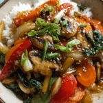 Vegetable stir fry with bok choy, carrots, mushrooms, and peppers in a wok
